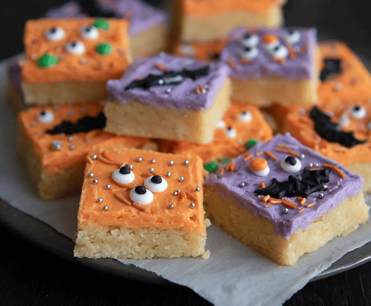 Decorative Halloween sugar cookie bars topped with colorful icing and spooky sprinkles, perfect for Halloween treats.