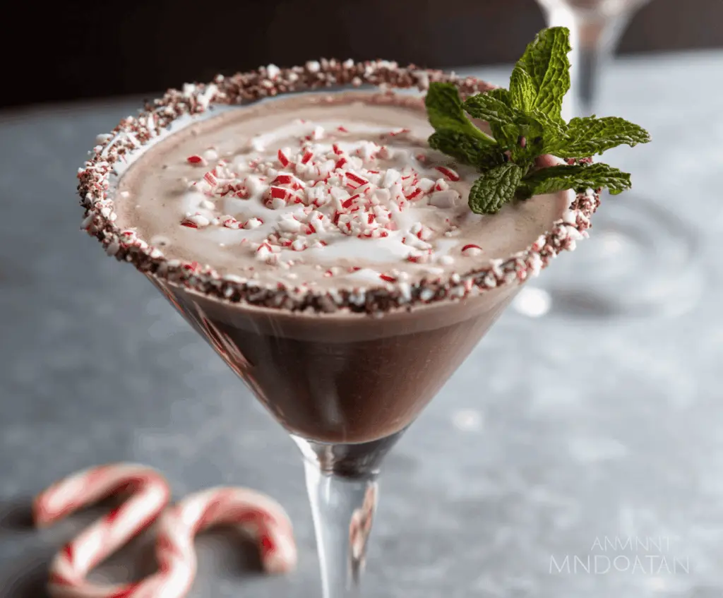 Delicious Chocolate Peppermint Martini with a chocolate candy garnish on a festive background.