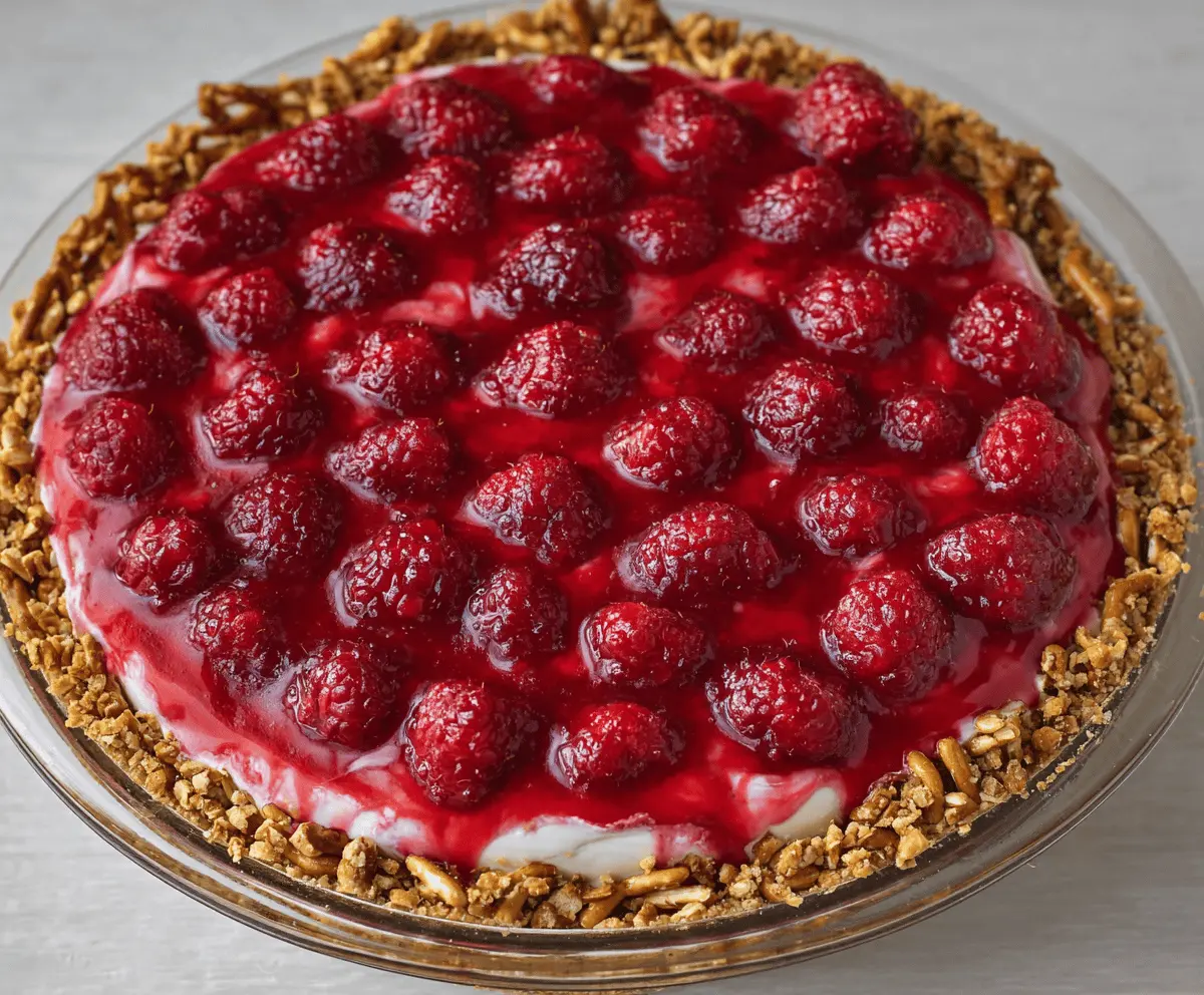 Delicious No-Bake Raspberry Pretzel Pie with fresh raspberries and crunchy pretzel crust.