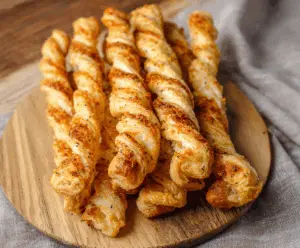 Golden Puff Pastry Parmesan Twists with crispy edges and cheesy topping, perfect for snacks or parties.