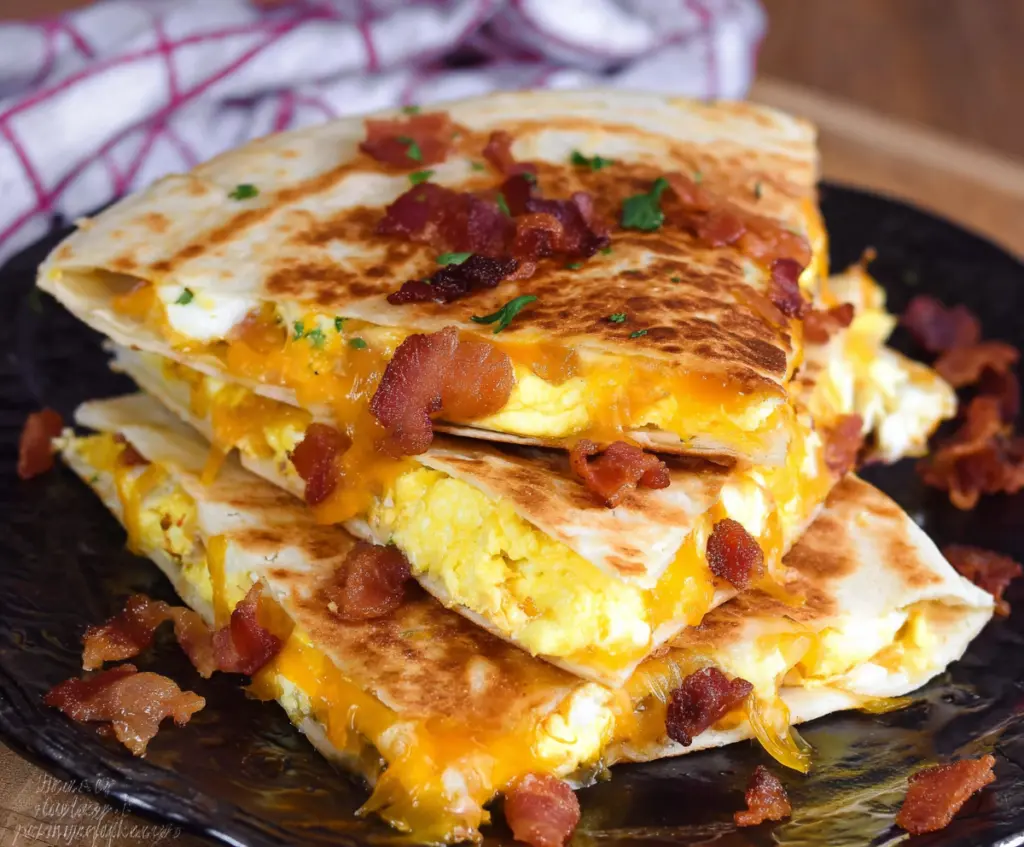 Delicious bacon, egg, and cheese breakfast quesadillas served hot with crispy edges.