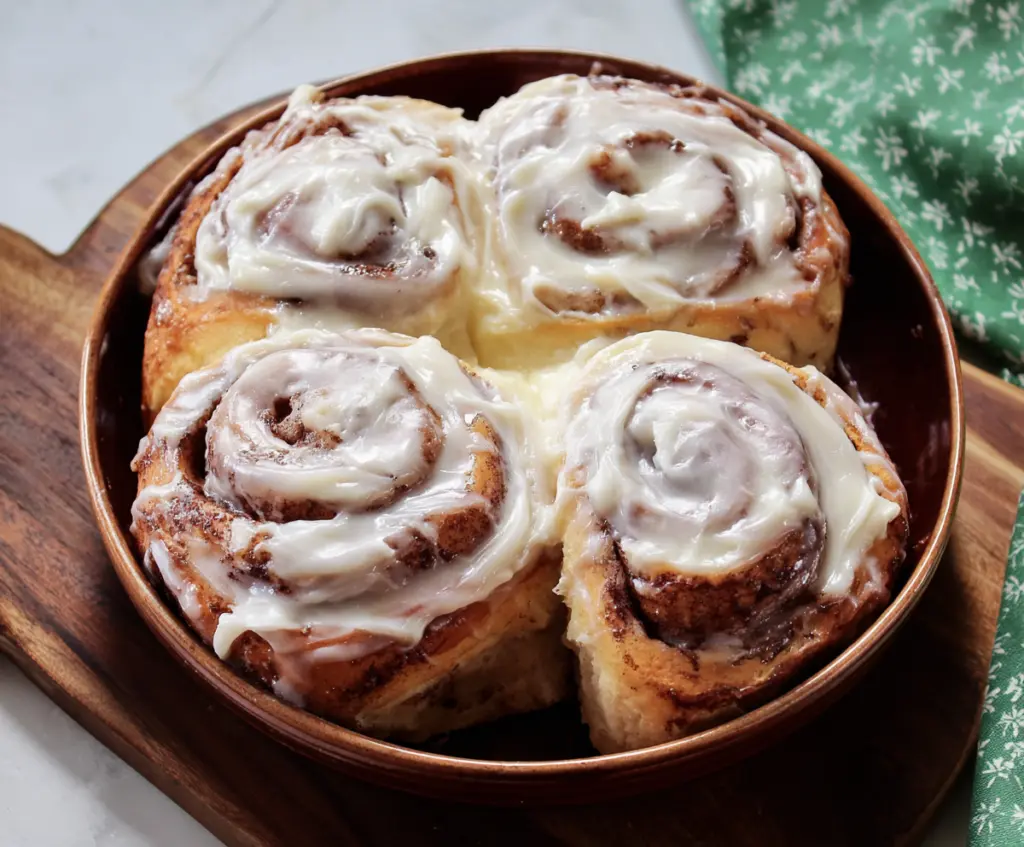 Delicious homemade cinnamon rolls topped with creamy cream cheese frosting, perfect for breakfast or dessert.