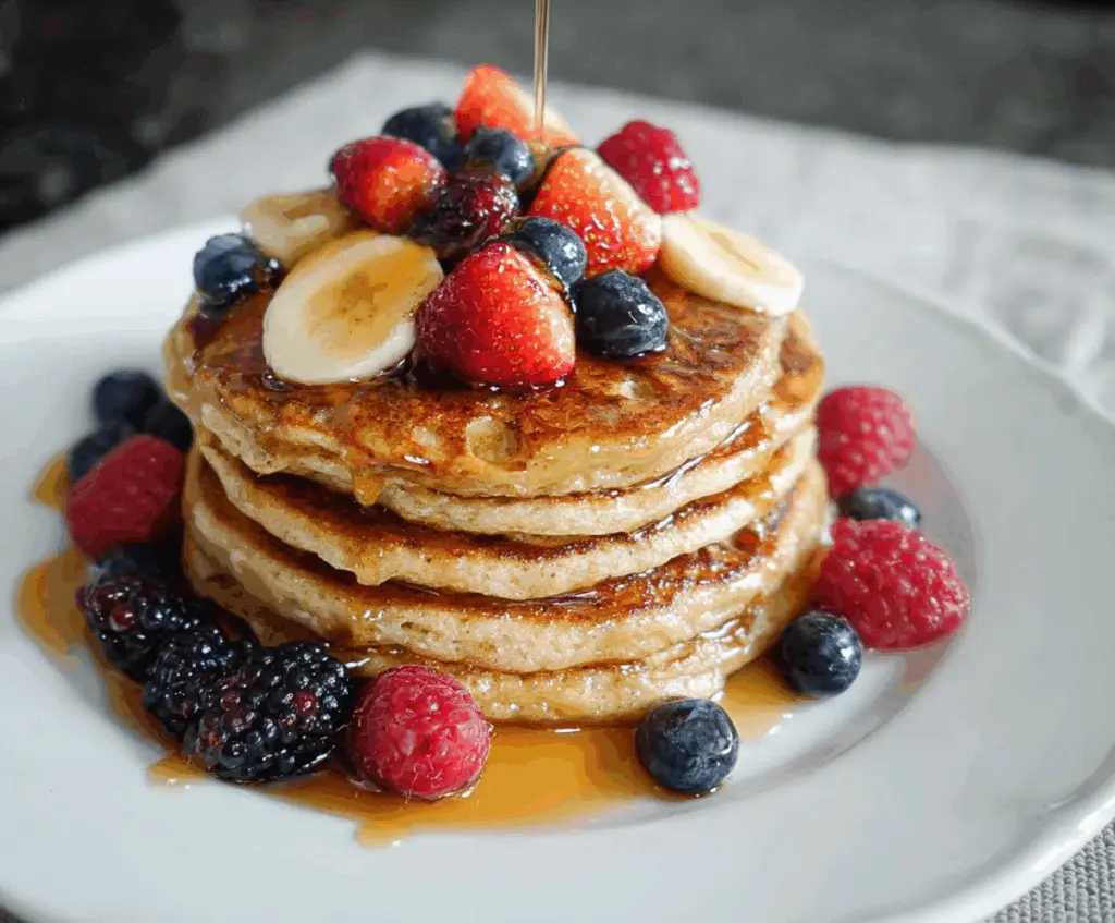 Healthy cottage cheese protein pancakes topped with fresh fruit for a nutritious breakfast.