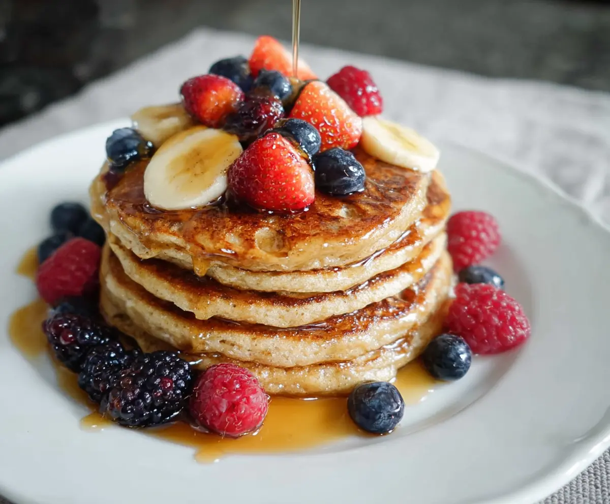 Healthy cottage cheese protein pancakes topped with fresh fruit for a nutritious breakfast.
