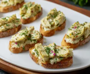 Delicious artichoke bruschetta topped with fresh herbs and olive oil on rustic bread.