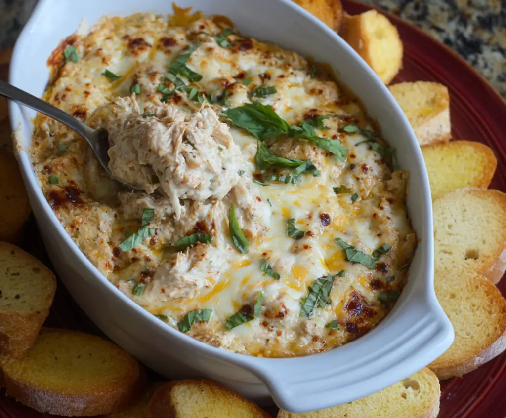 Delicious Crockpot Marry Me Chicken Dip served in a bowl, garnished with fresh herbs for a flavorful appetizer