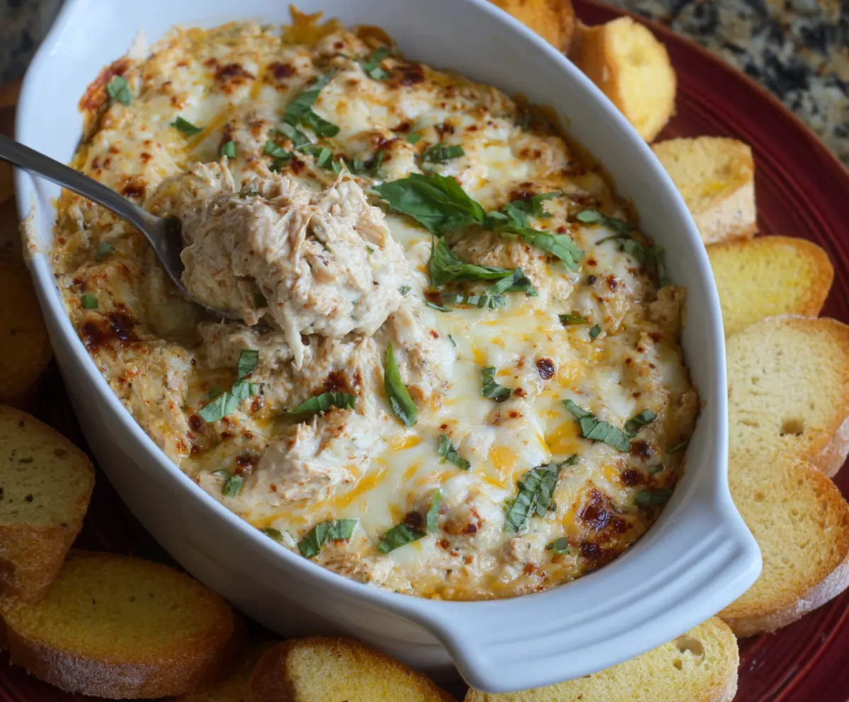 Delicious Crockpot Marry Me Chicken Dip served in a bowl, garnished with fresh herbs for a flavorful appetizer