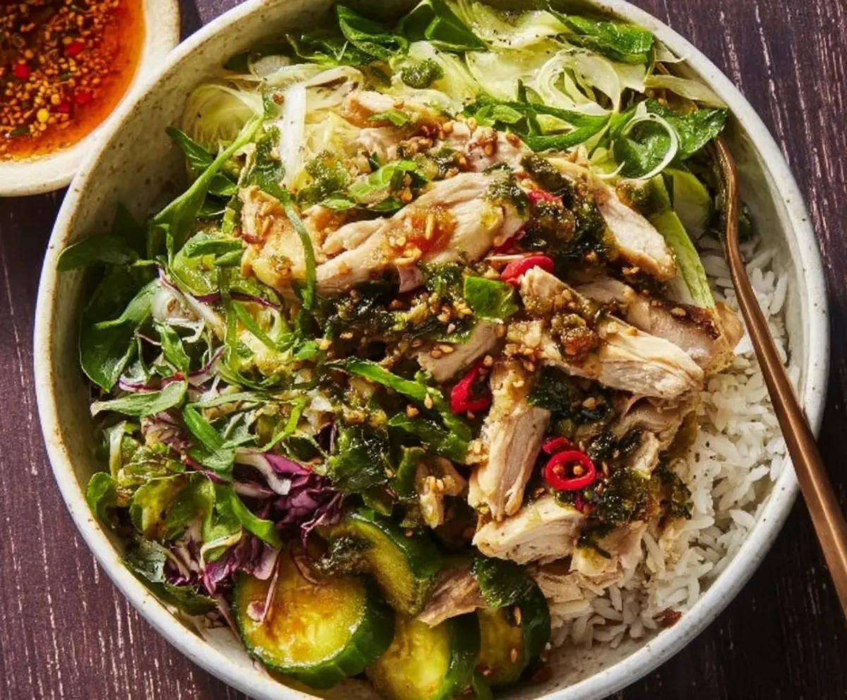 Ginger scallion chicken bowl served with rice and fresh greens in a modern bowl.
