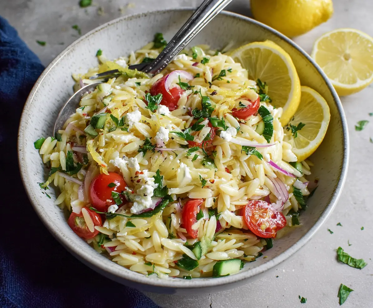 Fresh Lemon Orzo Pasta Salad with herbs and vegetables in a summer bowl